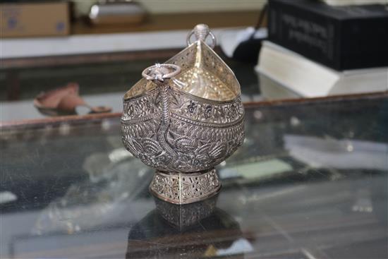 An Indian? white metal oval bowl with ring handles and three other items including two filligree items.